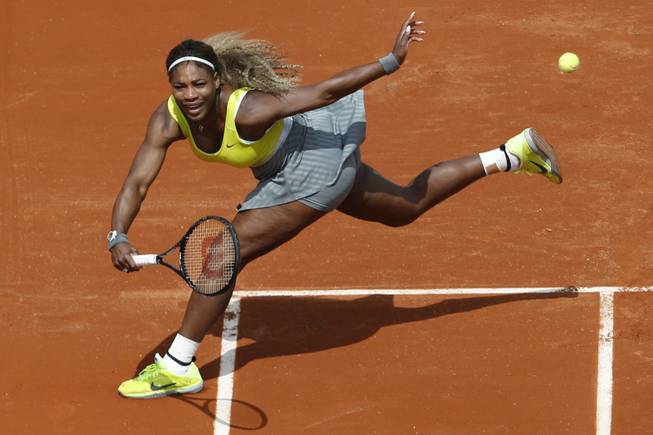 Serena Williams returns the ball during a first round match of the French Open tennis tournament against France's Alize Lim at the Roland Garros stadium, in Paris, France. Serena Williams could become the first woman in nearly 40 years to win three consecutive U.S. Opens, but she has not been past the fourth round at a major in 2014.