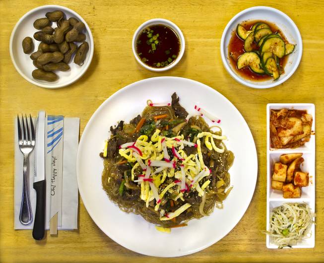 Island Style features the dish Japchae on Thursday, August 21, 2014.  (Upper left) It is joined by appetizers boiled peanuts, cucumbers, cabbage, radishes and bean sprouts.