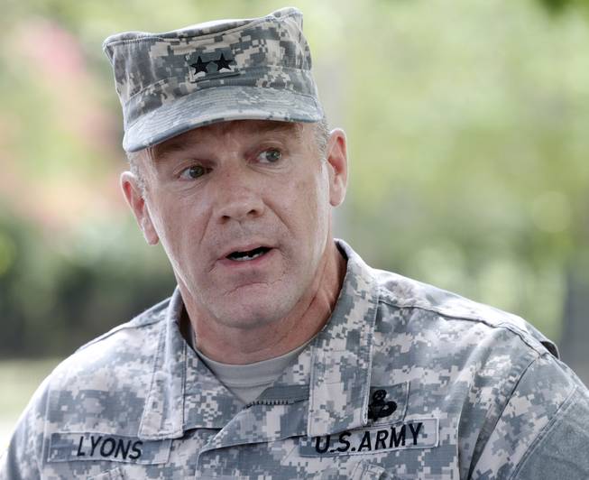 Army Maj. Gen. Stephen Lyons speaks during a news conference at the base in Fort Lee, Va., Monday, Aug. 25, 2014. A female soldier with a gun inside a key building at the Army base turned the weapon on herself, causing an injury, but didn't wound any others as the heavily trafficked base temporarily went on lockdown Monday morning.