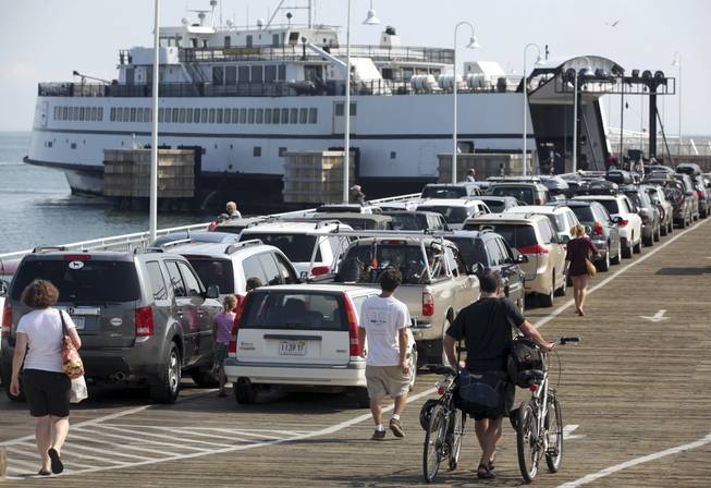 In this Aug. 26, 2011, file photo, passengers with cars and bicycles prepare to board a ferry departing the island of Martha's Vineyard, in Oak Bluffs, Mass. Leaders of the Aquinnah Wampanoag tribe propose to convert an unfinished community center on the island into a high-stakes bingo and poker hall, hoping to tap into the influx of tourist dollars each summer.