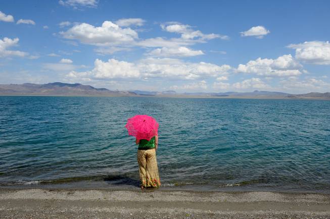 Janelle Coburn from Portland, Ore., enjoys the view of Pyramid Lake. She and friend Charles Lucas had come to Gerlach from the north but were turned away due to the wet playa. Like most of the Burners at Pyramid Lake, the change of venue was no big deal for the time being.