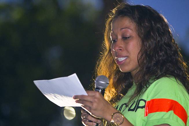 Brionna Simons cries as she reads a synopsis of the Michael Brown shooting during a vigil for Brown at Martin Luther King Boulevard and Carey Avenue Thursday, August 28, 2014. Brown, 18, was shot and killed by a police officer Aug. 9, 2014 in Ferguson, Mo.