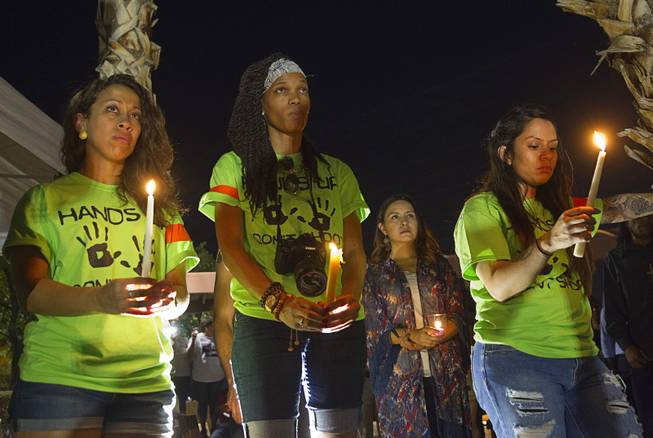 Organizers, from left, Briona Simons, Verise Johnson, and Liz Hernandez hold candles during a vigil for Michael Brown at Martin Luther King Boulevard and Carey Avenue Thursday, August 28, 2014. Brown, 18, was shot and killed by a police officer Aug. 9, 2014 in Ferguson, Mo.