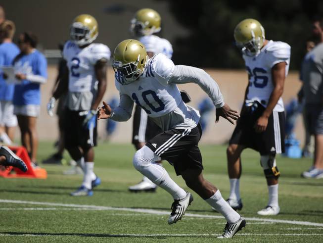 UCLA defensive back Fabian Moreau, center, sprints during NCAA college football practice Wednesday, Aug. 20, 2014, in Los Angeles. 