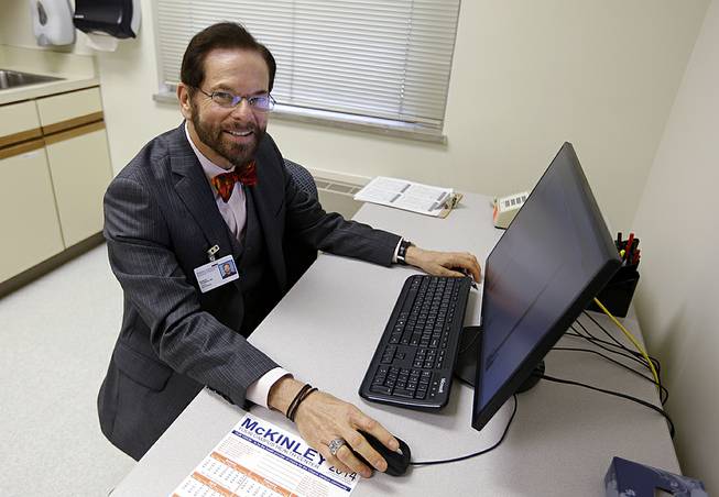 Dr. Robert Palinkas, director of the McKinley Health Center at the University of Illinois, poses in an exam room in Urbana, Ill., Thursday, Aug. 21, 2014. Extra health checks are part of protocols campuses throughout the United States have in place as they prepare for as many as 10,000 students from Nigeria, Guinea, Liberia and Sierra Leone, where more than 1,000 people have died in the worst Ebola outbreak in history. 