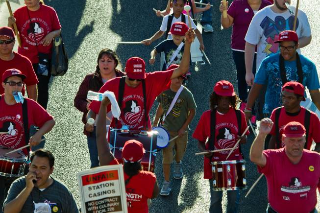 Adult and child drummers join in the march with culinary and bartender union members to Boulder Station to rally in support of fair jobs on Friday, August 29, 2014.