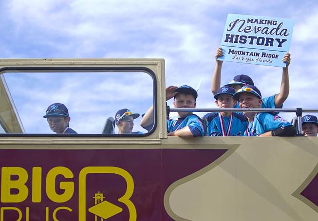 Members of the Mountain Ridge Little League team board a double-decker, open-air Big Bus following a ceremony at Las Vegas City Hall Saturday, Aug. 30, 2014.