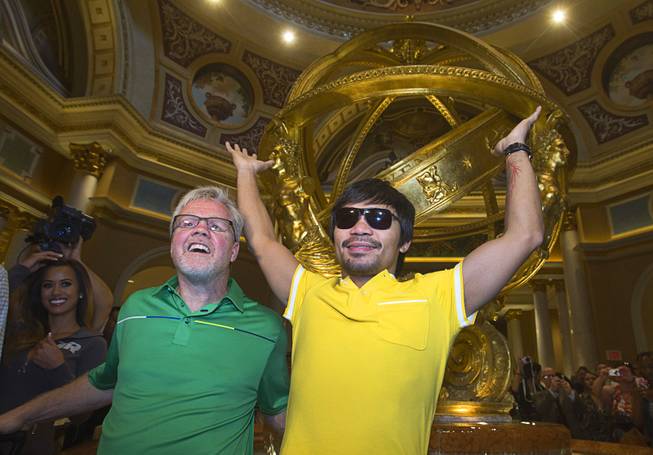 Trainer Freddie Roach, left, and boxer Manny Pacquiao of the Philippines pose in the lobby of the Venetian Saturday, Aug. 30, 2014. Pacquiao and his opponent Chris Algieri of Huntington, N.Y. are on day six of an international tour promoting their WBO welterweight title fight in Macau, China on November 22, 2014.