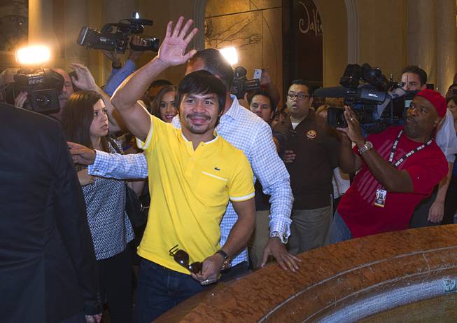 Boxer Manny Pacquiao of the Philippines waves to fans as he arrives at the Venetian Saturday, Aug. 30, 2014. Pacquiao and his opponent and Chris Algieri of Huntington, N.Y. are on day six of an international tour promoting their WBO welterweight title fight in Macau, China on November 22, 2014.