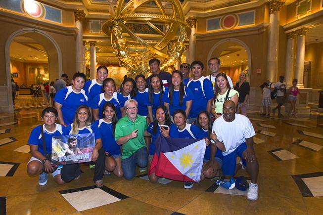 Boxing trainer Freddie Roach, center, poses with the Philippine Women's Softball team at the Venetian Las Vegas Resort in Las Vegas Nevada Aug. 30, 2014. The team is in Las Vegas training for the upcoming 17th Asian Games in Inchon, Korea. Boxers Manny Pacquiao of the Philippines and Chris Algieri of Huntington, N.Y. are on day six of an international tour promoting their WBO welterweight title fight in Macau, China on November 22, 2014.