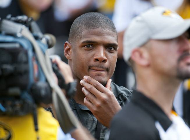 Former Missouri player Michael Sam watches pregame festivities before the start of the South Dakota State-Missouri NCAA college football game Saturday, Aug. 30, 2014, in Columbia, Mo. Sam, the first openly gay player drafted by an NFL team, was released by St. Louis Rams Saturday.
