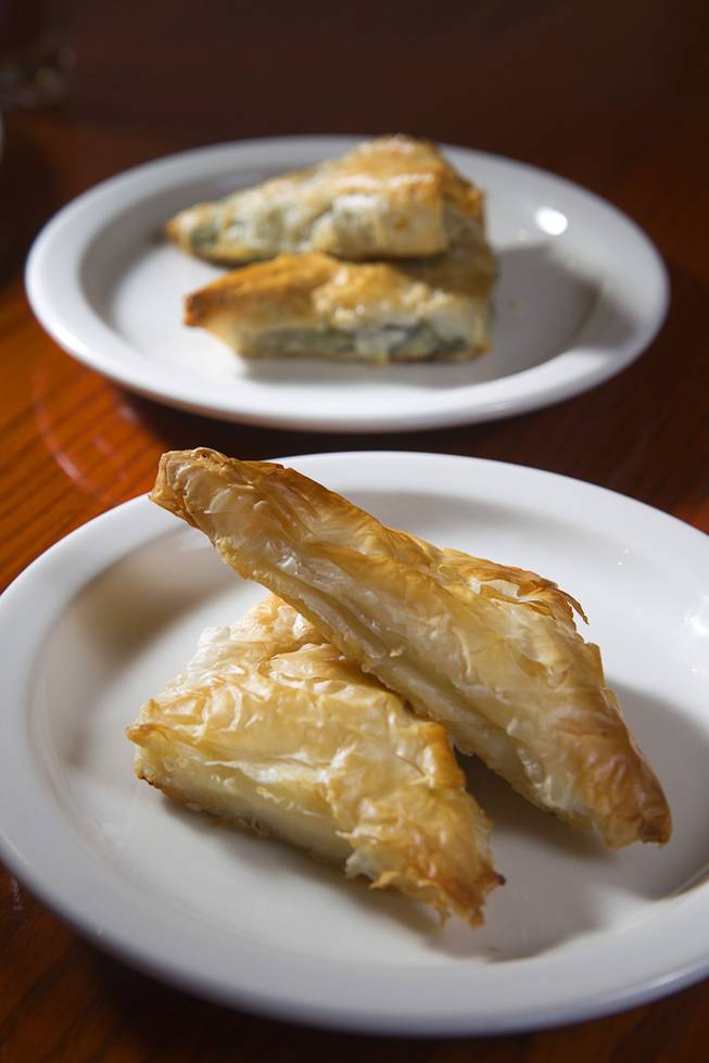 Tiropita, bottom, and Spanakopita are displayed at the E&N Family Table Restaurant, 4460 S. Durango Dr., Sunday, Aug. 31, 2014. Tiropita is Greek savory pastry with feta cheese. Spanakopita is the same but with feta cheese and spinach.
