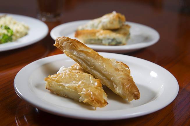 Tiropita, left, and Spanakopita are displayed at the E&N Family Table Restaurant, 4460 S. Durango Dr., Sunday, Aug. 31, 2014. Tiropita is Greek savory pastry with feta cheese. Spanakopita is the same but with feta cheese and spinach.