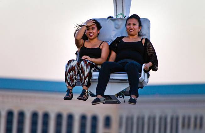 Riders look to the end of the line while taking on the Voodoo Zipline atop The Rio Hotel and Casino on Thursday, August 28, 2014.