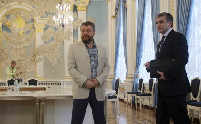 Russian Ambassador to Ukraine Mikhail Zurabov, right, and Pro-Russian rebel leader from Eastern Ukraine Andrei Purgin stand in Minsk, Belarus, on Monday, Sept. 1, 2014. A so-called contact group meets for talks in Minsk, the Belarusian capital, to reach agreement on a cease-fire. The group, which last met in late July, includes representatives of Ukraine, Russia and the Organization for Security and Cooperation in Europe. 