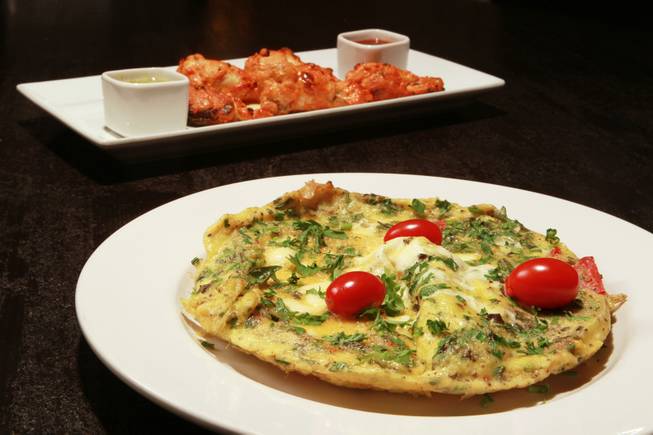 Omelette aux fines herbs and Tandoori chicken wings prepared by Origin India on Friday, Aug. 29, 2014, in Las Vegas.