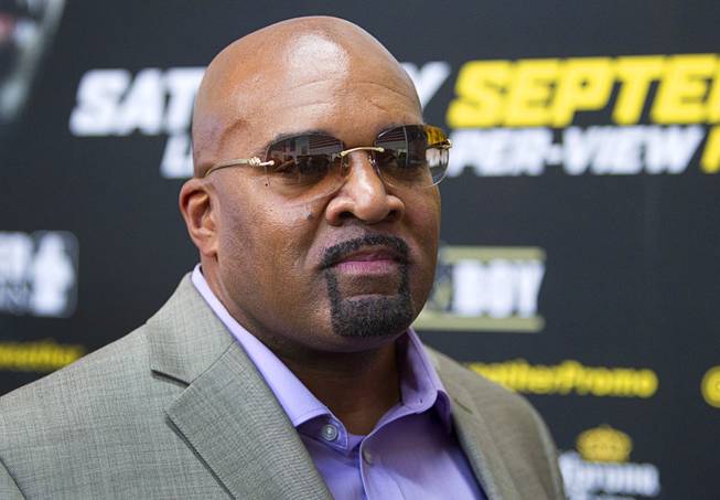 Leonard Ellerbe, CEO of Mayweather Promotions, watches as WBC/WBA welterweight champion Floyd Mayweather Jr. speaks with reporters during a media day at the Mayweather Boxing Club Tuesday, Sept. 2, 2014. Mayweather will face Marcos Maidana of Argentina in a rematch at the MGM Grand Garden Arena on Saturday, Sept. 13.