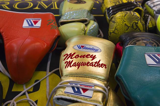 Customized gloves and pads are displayed as WBC/WBA welterweight champion Floyd Mayweather Jr. works out during a media day at the Mayweather Boxing Club Tuesday, Sept. 2, 2014. Mayweather will face Marcos Maidana of Argentina in a rematch at the MGM Grand Garden Arena on Saturday, Sept. 13.