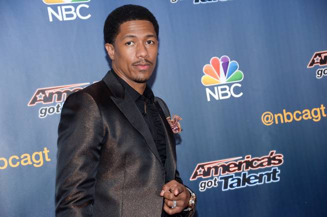 FILE - In a Tuesday, July 29, 2014 file photo, host Nick Cannon arrives at the "America's Got Talent" pre-show red carpet at Radio City Music Hall, in New York. Scholastic announced Tuesday, Sept. 2, 2014 that Cannon’s “Neon Aliens Ate My Homework and Other Poems”, a book of poems for children, will be published in March 2015. 