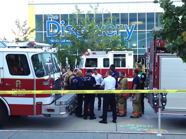Firefighters confer outside the Nevada Discovery Museum in Reno, Wednesday, Sept. 3, 2014. A minor explosion during a science experiment at the museum burned several children and forced the evacuation of the museum.