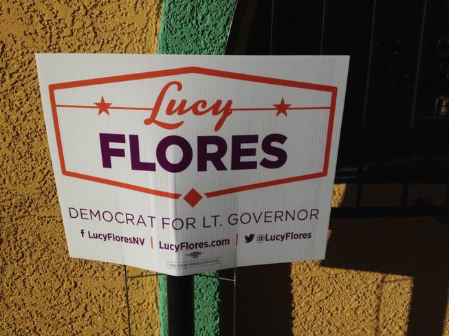 A promotional sign for Lt. Gov candidate Lucy Flores is pinned to the wall outside a Hispanics in Politics breakfast, where Flores and Republican Mark Hutchison are staging a debate Sept. 3, 2014. 