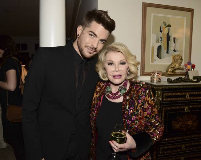 Singer Adam Lambert, left, and comedian Joan Rivers at the "Glamorous By George" book launch hosted by Joan and Melissa Rivers on Monday, Jan. 13, 2014 in Los Angeles. 