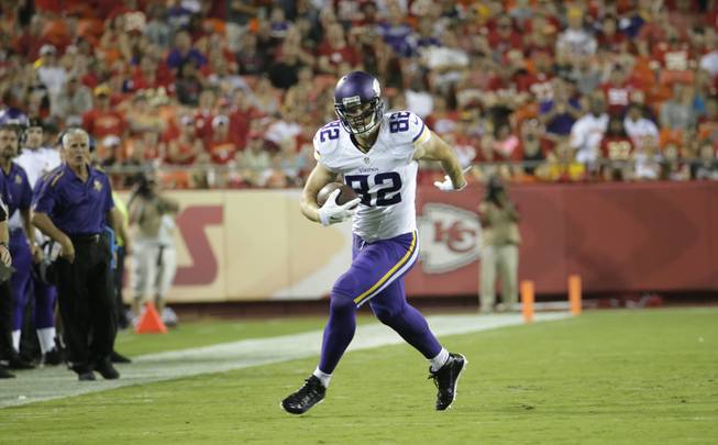 Minnesota Vikings tight end Kyle Rudolph (82) runs with the ball during the first half of an NFL preseason football game against the Kansas City Chiefs in Kansas City, Mo., Saturday, Aug. 23, 2014.
