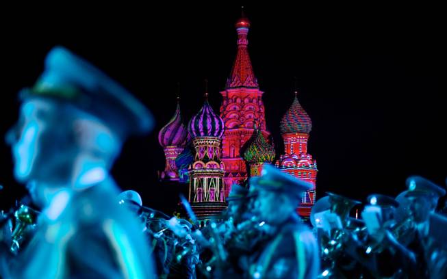 AP10ThingsToSee- St. Basil Cathedral is lit using show lights as Serbian Nish military band members perform during the rehearsal of "Spasskaya Tower" International Military Orchestra Music Festival at the Red Square in Moscow, Russia, Friday, Aug. 29, 2014. 