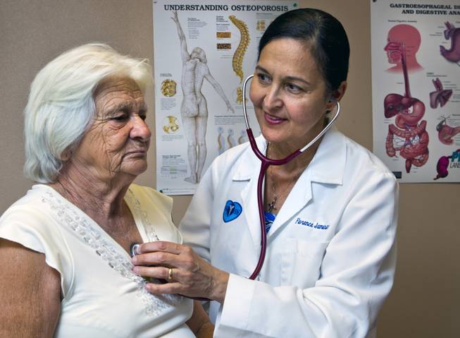 (From right) Dr. Florence Jameson, a veteran OB/GYN in town, checks on patient Maria Sosa-Cuellar at the Volunteers in Medicine on Wednesday, September 3, 2014.  Jameson is is also the volunteer CEO there which opened its first clinic a few years ago to serve uninsured patients. 