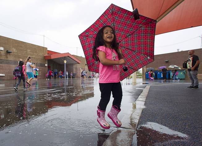 Keala Alcisto, 3, jumps in a puddle while waiting for her brother and cousin at Forbuss Elementary School Monday, Sept. 8, 2014. 
