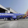A Southwest Airlines plane sporting the newly unveiled paint color scheme sits outside a hanger after an event at Love Field Monday, Sept. 8, 2014, in Dallas. 