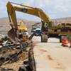 Las Vegas Paving workers repair the northbound lanes of Interstate 15 near Moapa Tuesday, Sept. 9, 2014. About 1 mile of freeway was severely damaged by runoff from Monday's storm. The Nevada Department of Transportation expects to have two lanes open by the weekend, a spokesman said.