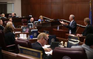 Steve Hill, with the Governor's Office of Economic Development, second from right, answers questions on the Senate floor during the second day of a special session at the Nevada Legislature, Thursday, Sept. 11, 2014,  in Carson City, Nev.  Lawmakers are  considering an unprecedented package of up to $1.3 billion in incentives to bring Tesla Motors' $5 billion battery factory to the state.