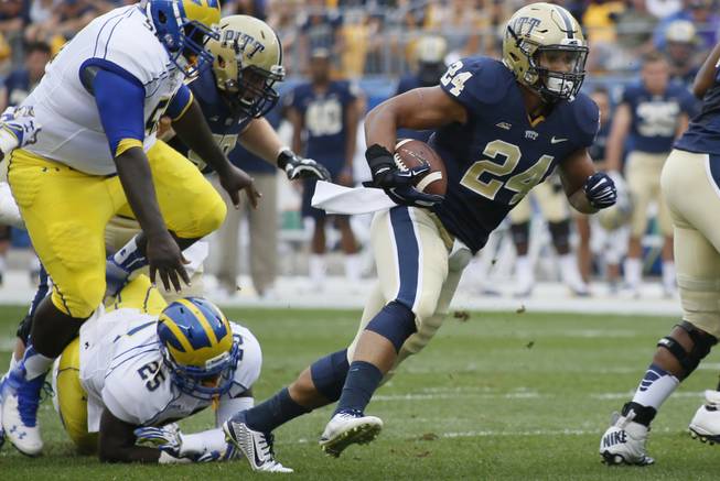 Pittsburgh running back James Conner (24) plays against the Delaware in the NCAA football game on Saturday, Aug. 30, 2014 in Pittsburgh. (AP Photo/Keith Srakocic)