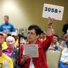 Mary Beth Earley of East Greenbush, N.Y., speaks against a casino in her town during a public meeting on casinos on Monday, Sept. 22, 2014, in Albany, N.Y. Supporters and critics of proposals for an Albany area casino are weighing in as three days of public hearings on casinos planned for upstate New York get underway. Earley holds a sign with the number of people who signed a petition opposing a casino.