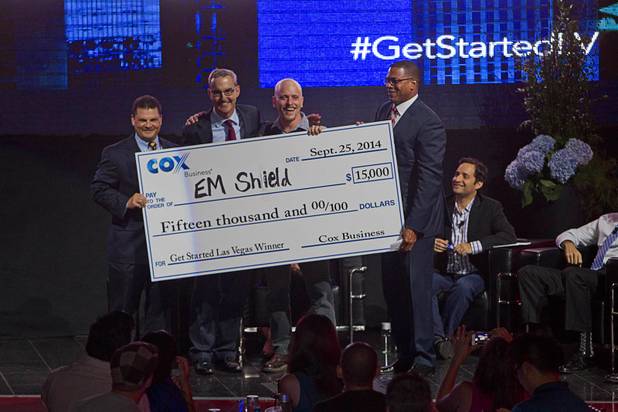 R Blank of EM Shield, third left, poses with Cox Business executives after winning the "Get Started Las Vegas" event at the Palms' Rain nightclub Thursday Sept. 25, 2014. From left are: Jeff Breaux, vice president of West Region Sales and Operations, Ken Kraft, corporate vice president of Marketing, and Derrick Hill, vice president of Cox Business and Hospitality Networks Las Vegas. Cox Business sponsored the "Shark Tank"-style event where a handful of start-ups and business owners competed for a $15,000 prize package.