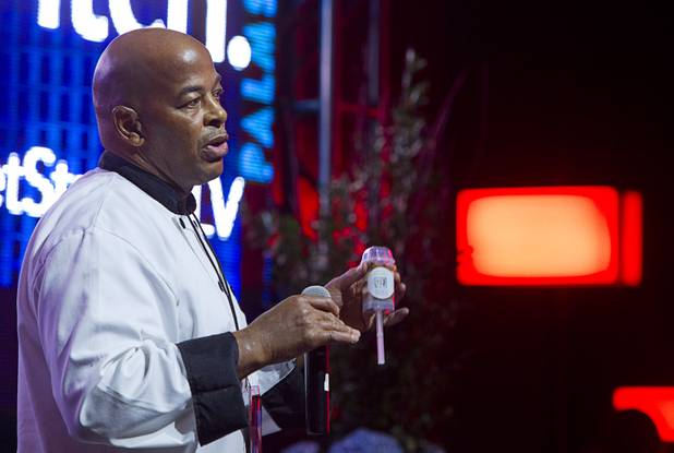 Michael Childrey of Michaela's Decadent Desserts, hold a push-up, carrot cake pop as he makes a pitch during a "Get Started Las Vegas" event at the Palms' Rain nightclub Thursday Sept. 25, 2014. Cox Business sponsored the "Shark Tank"-style event where a handful of start-ups and business owners competed for a $15,000 prize package.