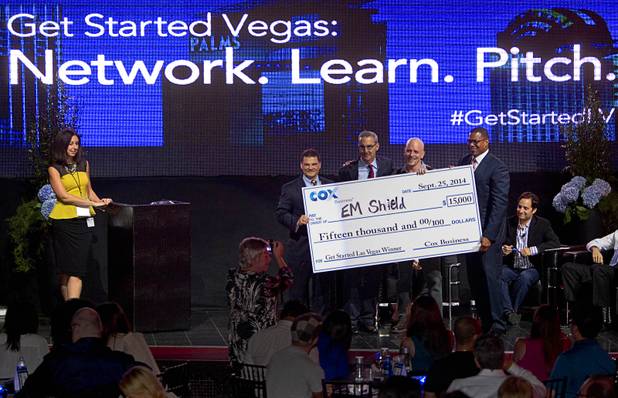 R. Blank of EM Shield, third left, poses with Cox Business executives after winning the "Get Started Las Vegas" event at the Palms' Rain nightclub Thursday Sept. 25, 2014. From left are: Jeff Breaux, vice president of West Region Sales and Operations, Ken Kraft, corporate vice president of Marketing, and Derrick Hill, vice president of Cox Business and Hospitality Networks Las Vegas. Shana Keith, public relations director for Cox Business is at far left.