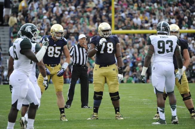 Notre Dame lineman Ronnie Stanley, middle, lines up during in a NCAA college football game with Michigan State Sept. 21, 2013 in South Bend, Ind. At left is Notre Dame tight end Troy Niklas. (AP Photo/Joe Raymond)