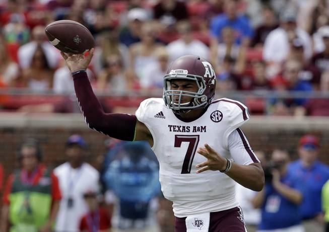 Texas A&M quarterback Kenny Hill (7) passes against SMU in the first half of an NCAA college football game,  Saturday, Sept. 20, 2014, in Dallas. (AP Photo/Tony Gutierrez)
