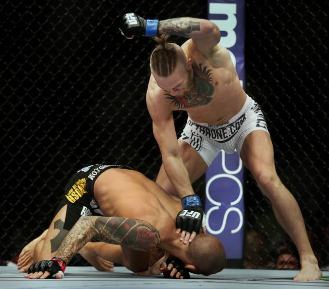 Featherweight fighter Conor McGregor pounds on a defenseless Dustin Poirier, who was kicked to the ground and would soon be eliminated, during UFC 178 on Saturday, Sept. 27, 2014, at MGM Grand Garden Arena.