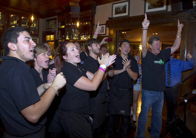 Employees applaud during a kick-off for a Guinness World Record attempt at Ri Ra Irish Pub on Wednesday, Oct. 1, 2014, in Mandalay Place. Musician John Windsor is at right. The pub is attempting to break the Guinness World Record for longest music marathon performed by Irish bands. The current record is 15 days.