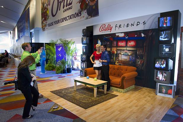 People have their photos taken on a "Friends" set during the Global Gaming Expo (G2E) at the Sands Expo Center Thursday, Oct. 2, 2014.