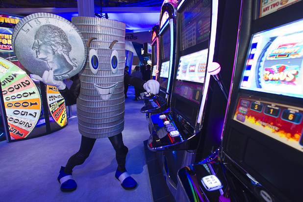 A Quartermania costumed character poses by a bank of Quartermania slot machine at the IGT booth during the Global Gaming Expo (G2E) at the Sands Expo Center Thursday, Oct. 2, 2014.