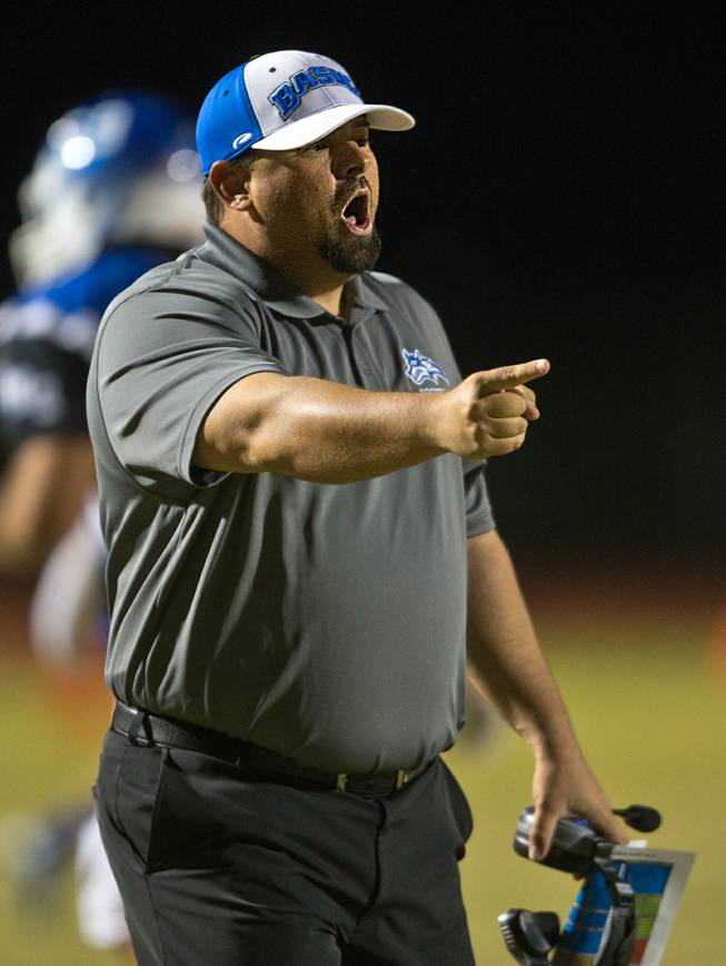 Basic High School head coach Jeff Cahill argues a poor spot near the end zone which gives the ball back to Green Valley in the Henderson Bowl on Wednesday, October 2, 2014.