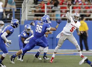 UNLV quarterback Blake Decker, right, passes under pressure from San Jose State's Vince Buhagiar (36) during the first half of an NCAA college football game Saturday, Oct. 4, 2014, in San Jose, Calif. 