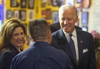Vice President Joe Biden meets with business owner Louisa Mendoza, left, and restaurant owner Javier Barajas before a round-table discussion on raising the minimum wage at Casa Don Juan restaurant Monday, Oct. 6, 2014.