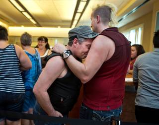 Morgan Floyd is consoled by David Parry as same-sex couples wait for hours hoping to get licenses from the Marriage Bureau only to leave disappointed on Wednesday, October 8, 2014. .
