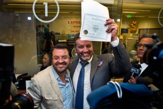 Antioco Carillo-Miramonts and Theodore Small are the first in Clark County to receive a same-sex marriage certificate Thursday, Oct. 9, 2014, at the Marriage License Bureau.