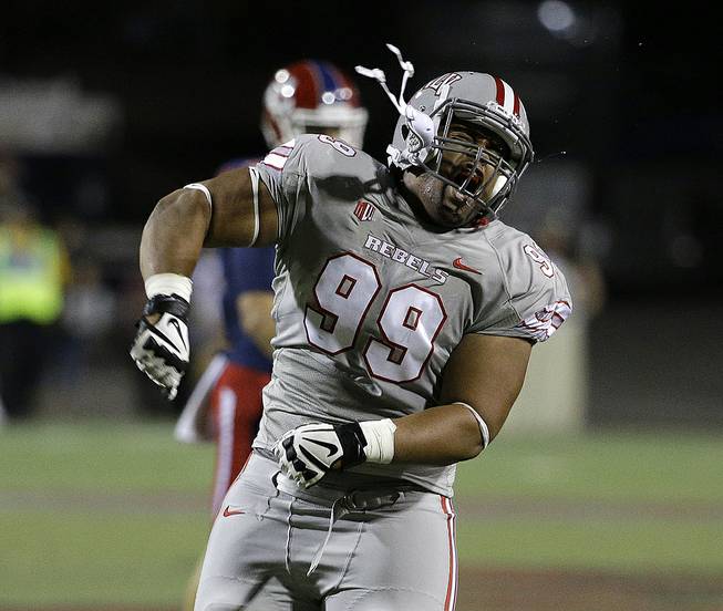 UNLV Rebels defensive lineman Mike Hughes Jr. celebrates after keeping Fresno State from a first down during the first half of their game Friday, Oct. 10, 2014, in Las Vegas. 